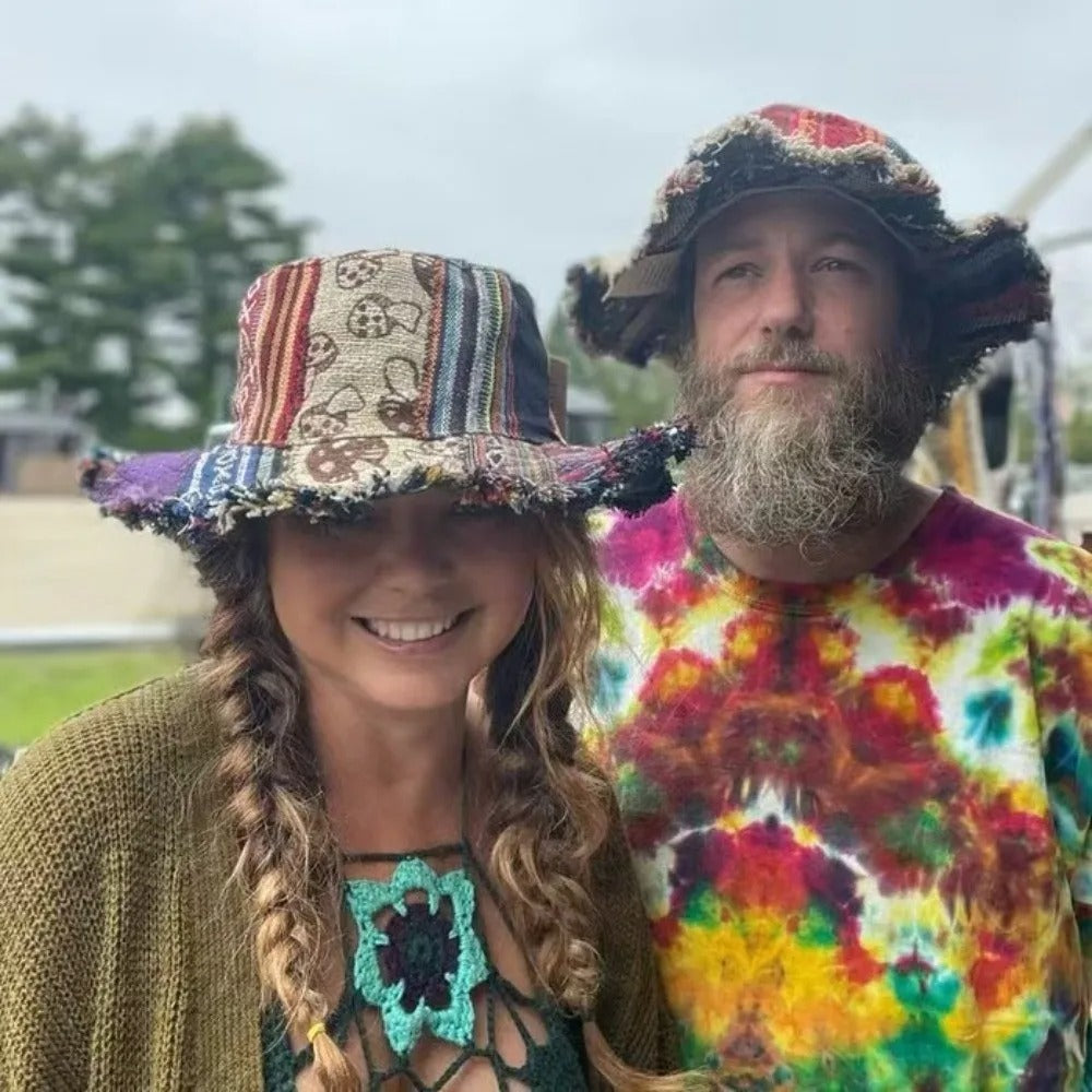 Two people wearing colorful hats and clothing, standing outdoors.
